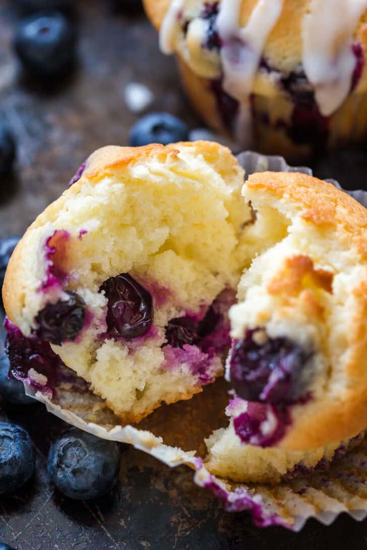 These Blueberry Muffins are bursting with juicy blueberries. They have a soft and moist crumb and puff up perfectly. The lemon glaze makes them completely irresistible and they always disappear fast! Center of a homemade blueberry muffin