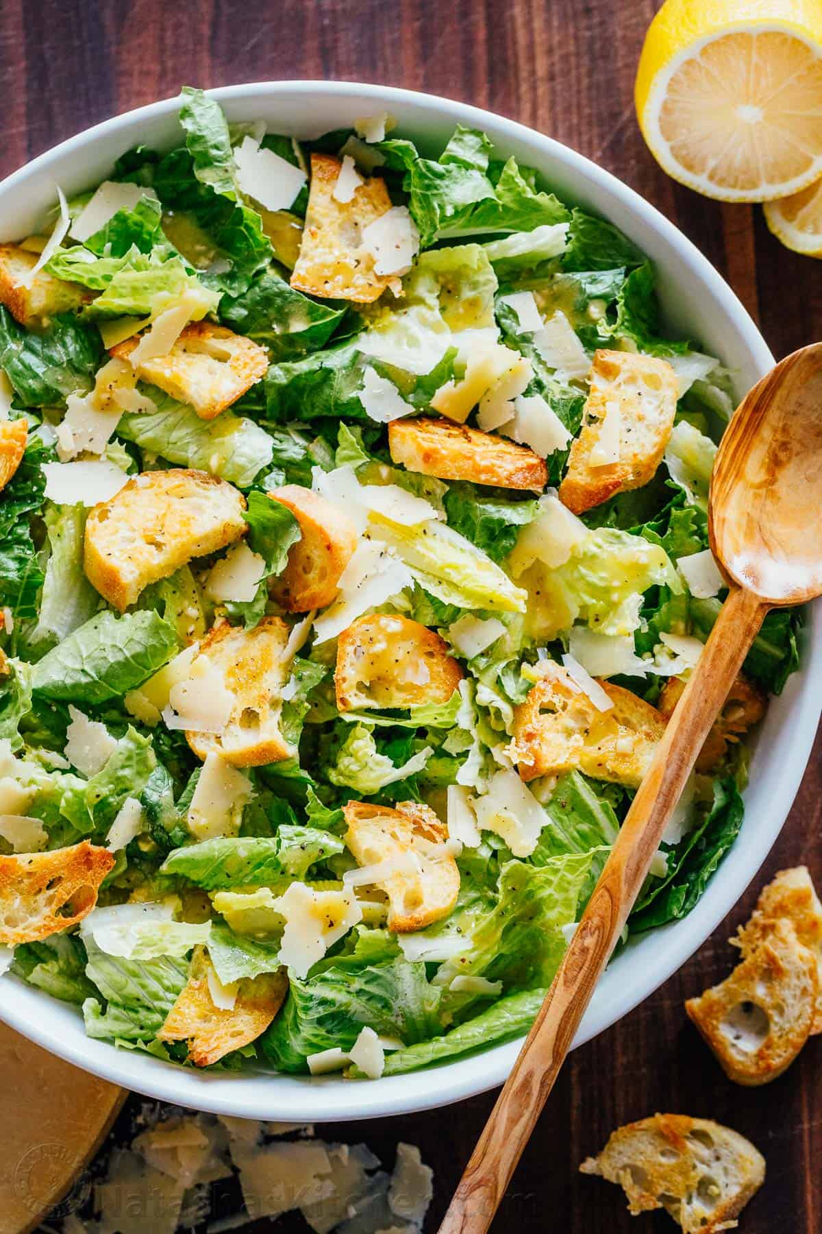 A classic Caesar Salad recipe with crisp romaine lettuce, fresh parmesan cheese, crunchy homemade croutons, and a light Caesar dressing. Classic Caesar Salad in a bowl with homemade croutons, shaved parmesan and caesar salad dressing