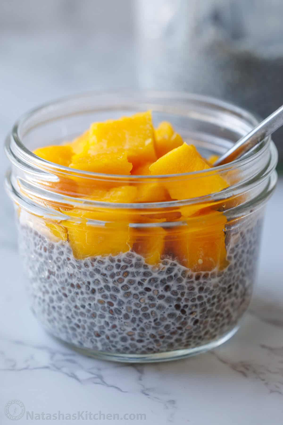 Chia Seed Pudding uses only 3 ingredients to make a delicious and filling breakfast you can prep ahead. Add toppings for the perfect bite. Mango chia pudding in a small jar with a spoon