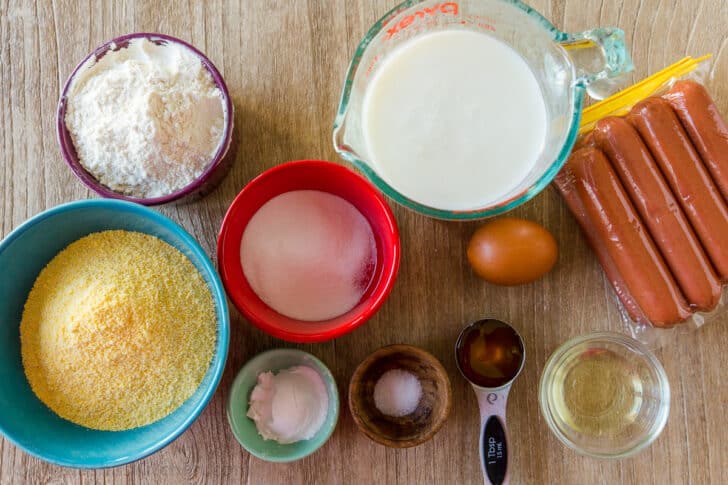 Ingredients for corn dogs ingredients for corn dogs with corn meal, hot dogs and batter ingredients