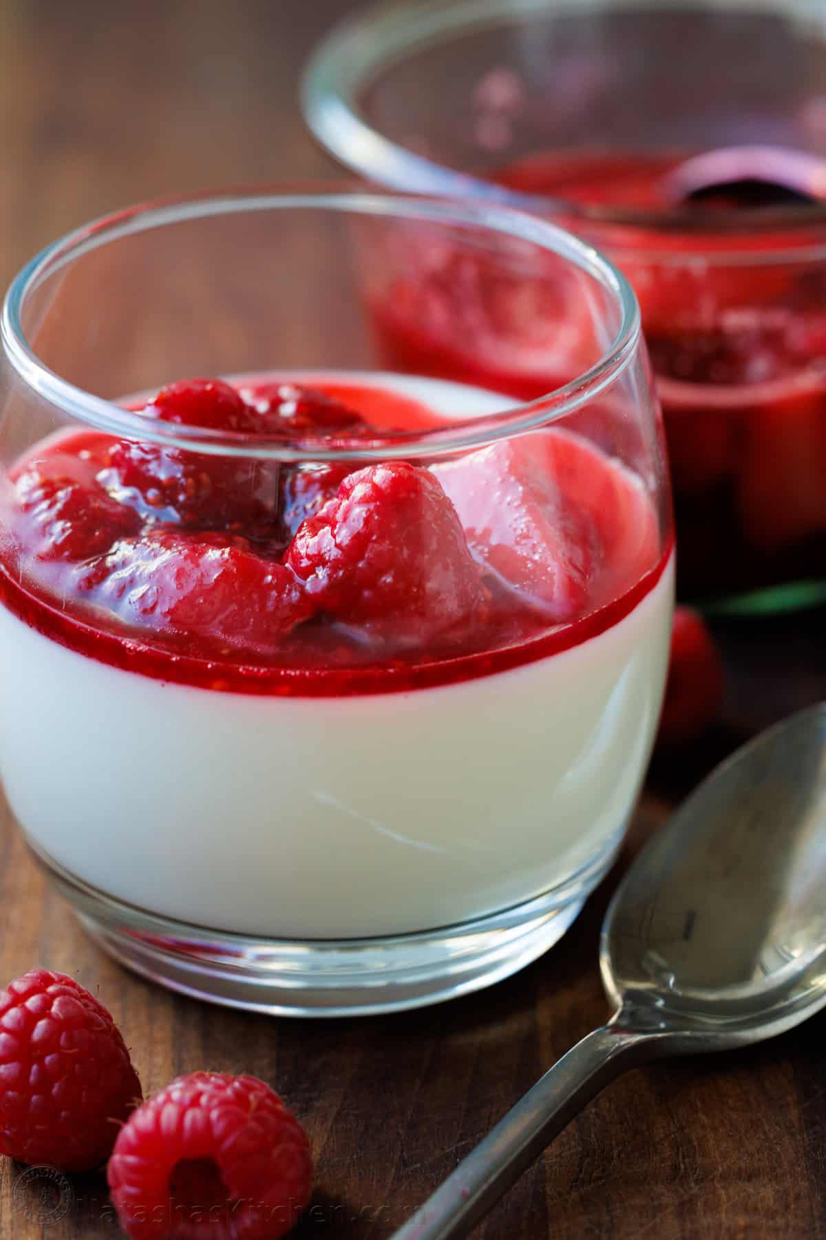 Panna Cotta is an Italian dessert that looks and tastes fancy but is so quick and easy to make! The fresh berry sauce gives every creamy spoonful the perfect balance of sweet and tangy. Panna Cotta served in a glass with fresh berry sauce on top