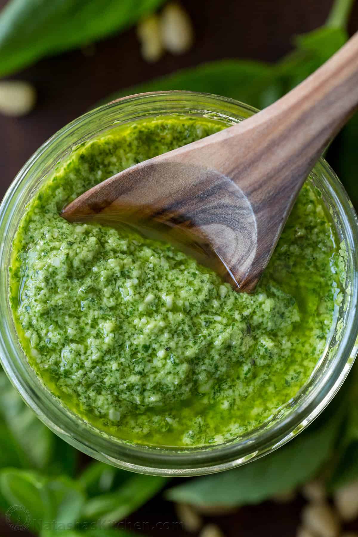 This homemade pesto tastes way better than storebought. Basil pesto is easy to make and so versatile as a sauce, dip, spread, and topping. spoonful of fresh basil pesto sauce