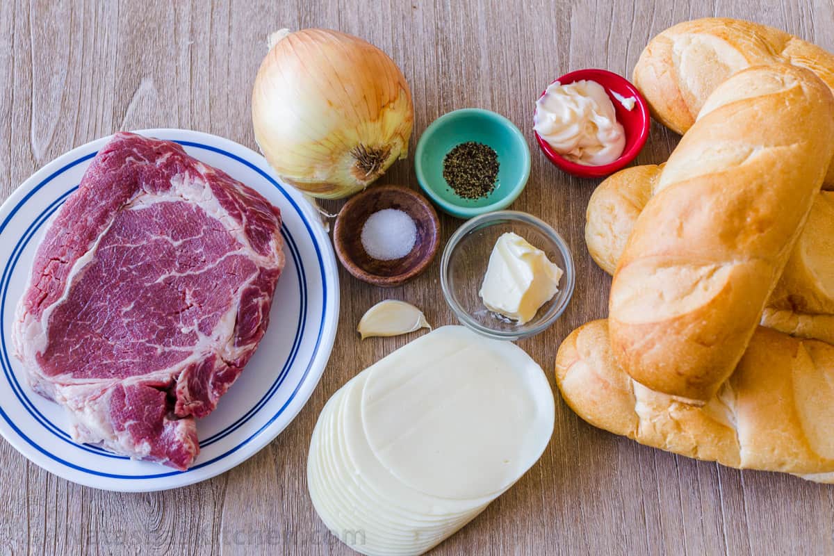 Ingredients for cheesesteak sandwich Ingredients for philly cheesesteak sandwich including ribeye steak, hoagie rolls, provolone cheese, onion, mayo, garlic butter