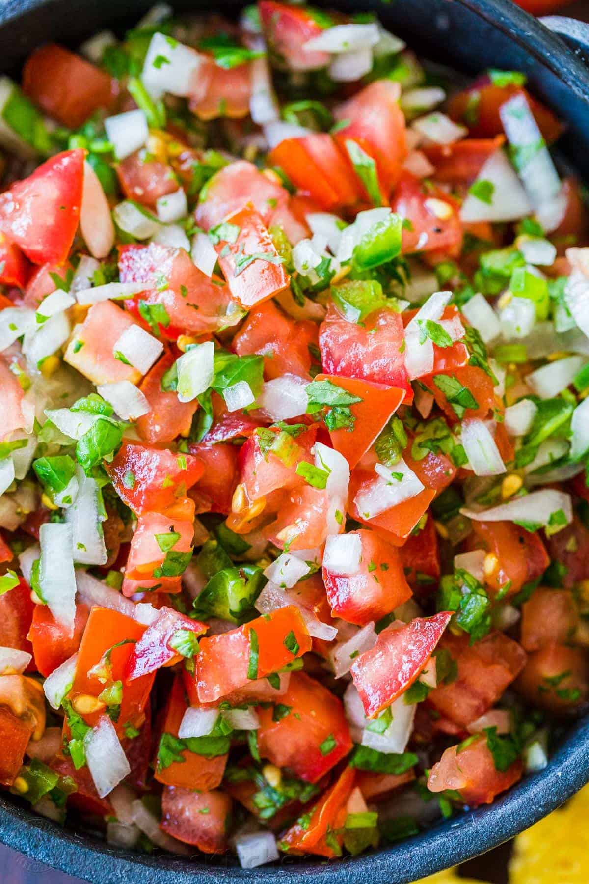 How to make the best Pico De Gallo with fresh tomatoes, onion, cilantro, jalapeno and lime juice. Learn the secret to authentic Mexican Pico De Gallo! #picodegallo #picodegallorecipe #salsa #summersalsa #mexicanpicodegallo #autheticpicodegallo #howtomakepicodegallo #natashaskitchen The best pico de gallo in a bowl