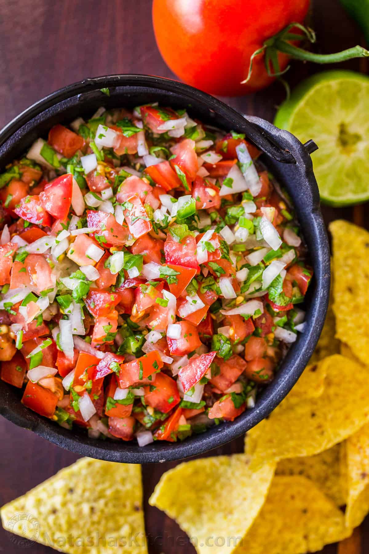How to make the best Pico De Gallo with fresh tomatoes, onion, cilantro, jalapeno and lime juice. Learn the secret to authentic Mexican Pico De Gallo! #picodegallo #picodegallorecipe #salsa #summersalsa #mexicanpicodegallo #autheticpicodegallo #howtomakepicodegallo #natashaskitchen Mexican Pico De Gallo served as salsa fresca in a bowl surrounded by chips