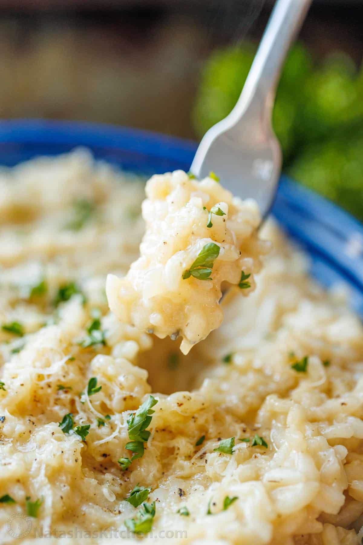 Creamy Parmesan Risotto is the ultimate Italian side dish. Learn how to make the best Risotto that can be modified in so many different ways. Risotto served on a fork