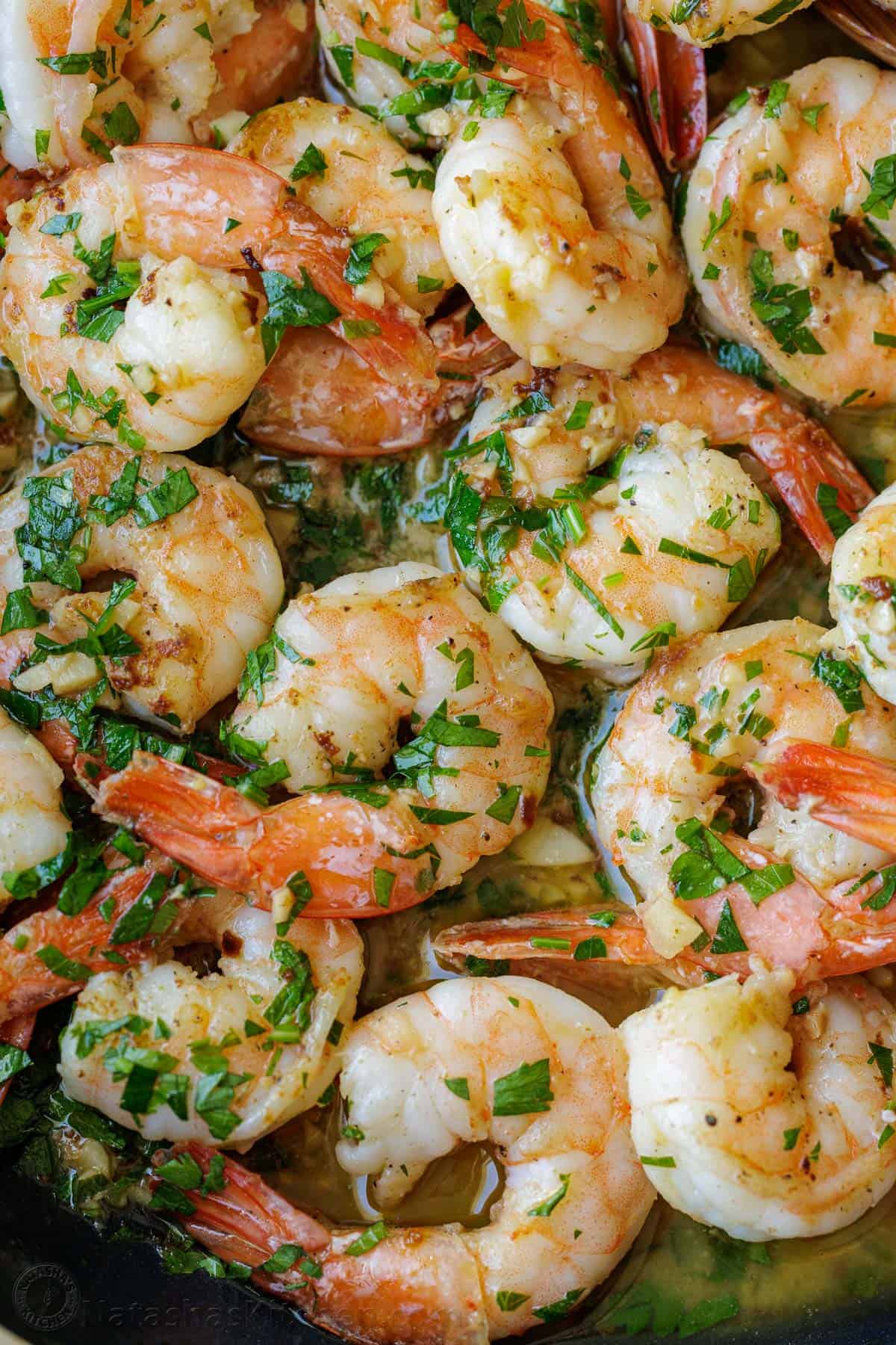 Shrimp Scampi Recipe with garlic, butter, and wine sauce drizzled with fresh lemon juice. This easy shrimp scampi takes just 10 minutes! Up close shrimp scampi in a lemon-garlic butter sauce with parsley garnish.