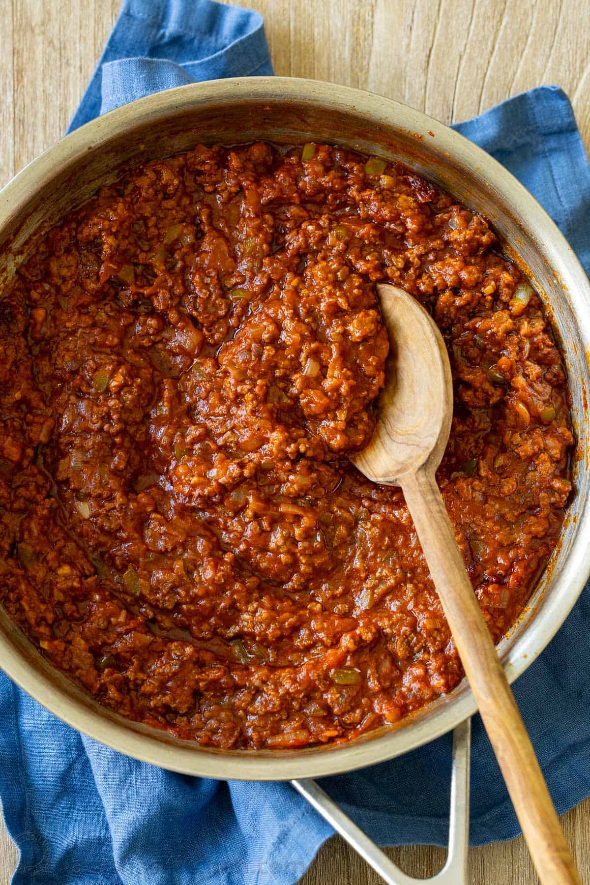 This delicious sloppy joe recipe is such a simple recipe and so inexpensive to make, a budget-friendly family dinner! saucy and beefy sloppy joe meat sauce cooked in a skillet with a mixing spoon
