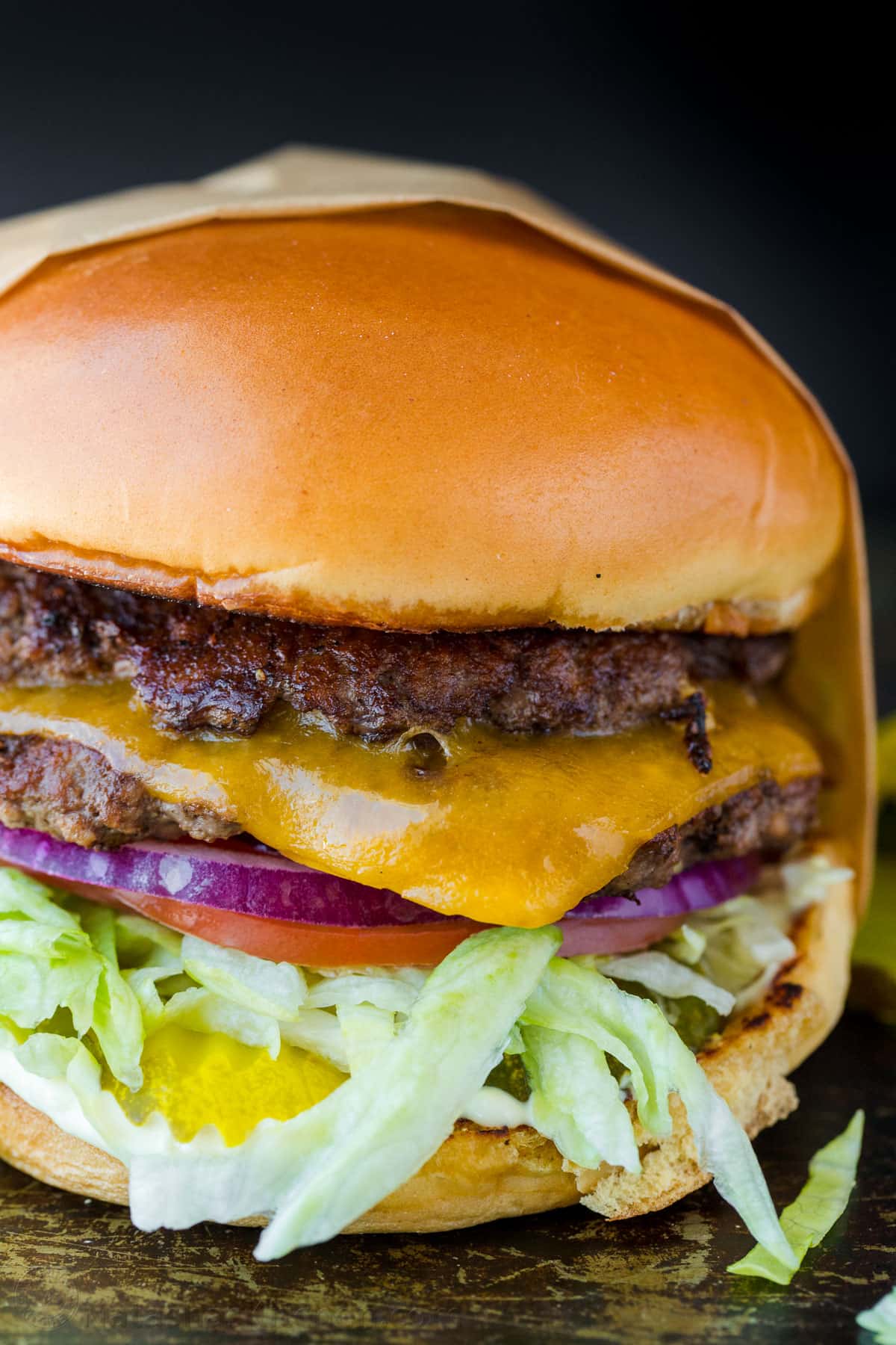 A restaurant-style Smash Burger is one of the tastiest ways to cook a burger. You’ll love the double patty with melted cheese in between. smash burger wrapped in parchment paper