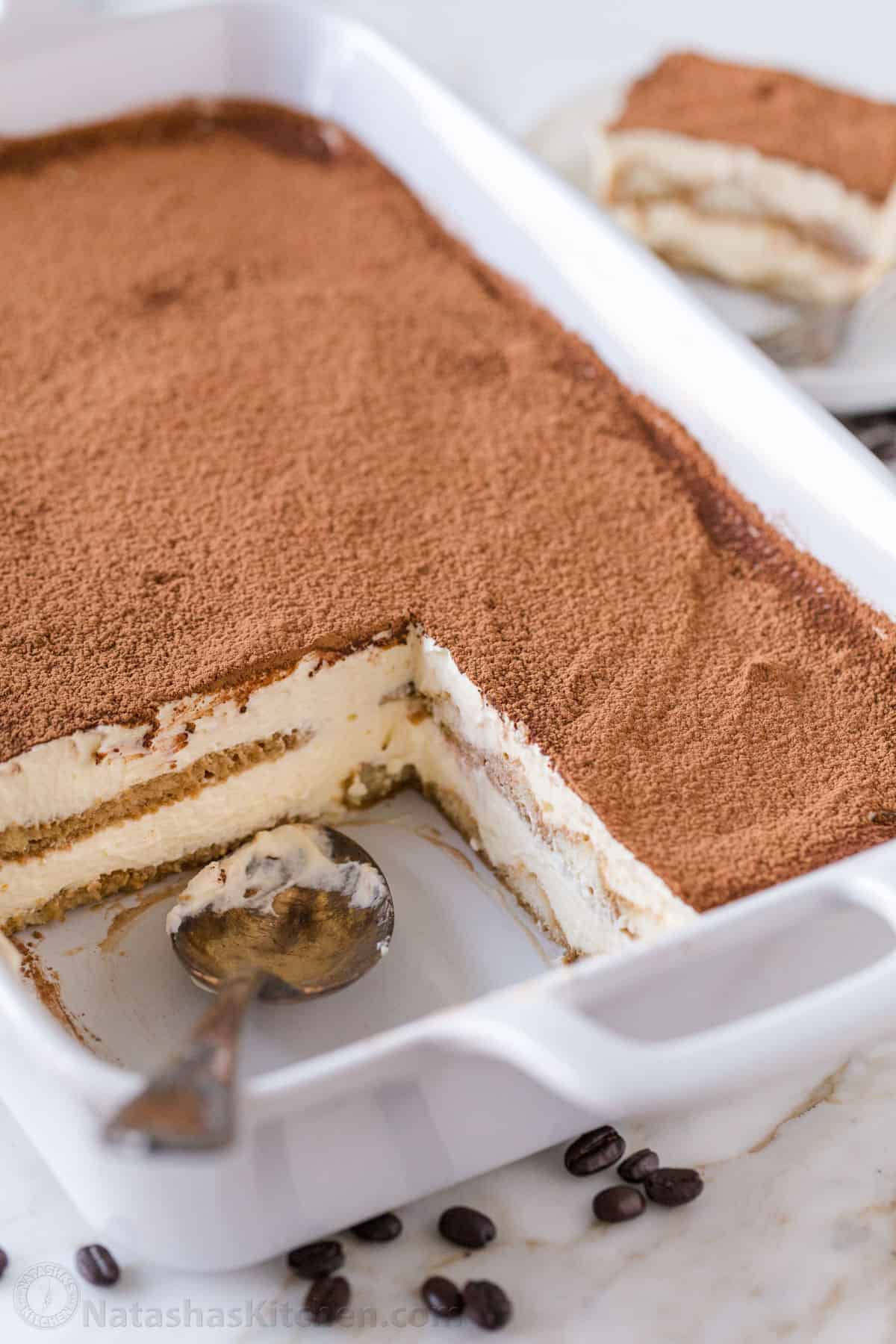 The best Classic Italian Tiramisu recipe with layers of coffee-soaked ladyfingers & decadent cream is so easy! Try my no-bake dessert recipe! homemade tiramisu recipe in a white dish with mascarpone cream layers and ladyfingers soaked in coffee