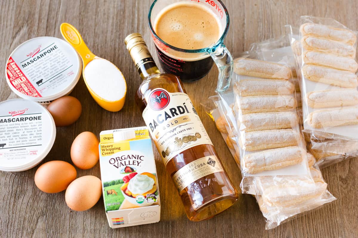 The best Classic Italian Tiramisu recipe with layers of coffee-soaked ladyfingers & decadent cream is so easy! Try my no-bake dessert recipe! ingredients for Italian layered dessert including mascarpone cheese, eggs, sugar, heavy whipping cream, rum, coffee and ladyfingers